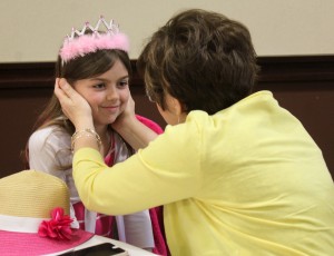 Sue Hawk looks on her goddaughter Isabelle Adams with love after the girl was crowned a "Jesus princess" at the April 30 event. They are from St. Mary Parish in Metamora. (The Catholic Post/Jennifer Willems)