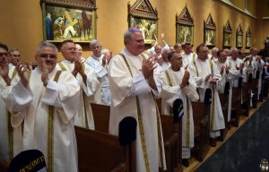 Dozens of permanent deacons from throughout the Diocese of Peoria applaud as members of Class X are accepted into the ministry of acolyte. (The Catholic Post/Tom Dermody)