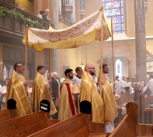 Father Michael Pica carries the Blessed Sacrament in a eucharistic procession throughout the newly restored cathedral. (The Catholic Post/Jennifer Willems)