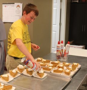While joy can be found in a well-prepared piece of pumpkin pie, sixth-graders at St. Mary School in Pontiac found that true JOY comes from serving Jesus, Others, Yourself, as they helped with the annual Thanksgiving luncheon at Sophia's Kitchen. (The Catholic Post/Jennifer Willems)