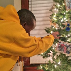 Kasaika Kabunze helps to decorate the family's first Christmas tree.