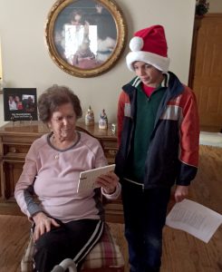 Cecelia Allen examines the gift given to her by Blessed Sacrament fifth-grader Joaquin Hoeft. The Morton students visited their pen pals and serenaded them with Christmas carols in  December. (Provided photo)
