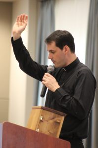 Father Tim Hepner, diocesan vocation director for recruitment, offers a blessing as he commissions participants at the Hundredfold Workshop. (The Catholic Post/Jennifer Willems)