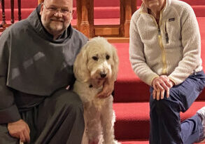 Father Witold Adamczyk, OFM Conv., pastor of Sacred Heart Parish in Rock Island, poses with therapy dog Bailey and her owner and trainer, parishioner Sharon Cramer. (Provided photo)