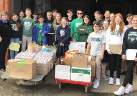 Seventh-graders from St. Patrick School in Washington deliver baby food and formula to the St. Gianna Baby Pantry of Catholic Charities in Peoria as part of the 50th annual Baby Food Project on March 31. With them is Kay Grillot, president of Tazewell County Right to Life. (The Catholic Post/Paul Thomas Moore)