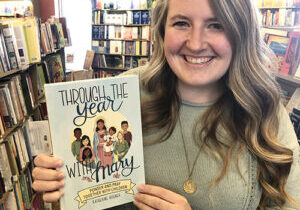 Katie Bogner holds a copy of her new book, "Through the Year with Mary: Ponder and Pray Together with Children." A popular blogger at looktohimandberadiant.com, Bogner is the director of religious education at Immaculate Conception Parish in Lacon and a junior high faith formation teacher at St. Philomena School in Peoria. (Provided photo)