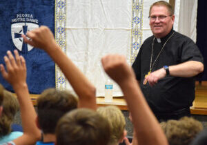 Hands go up as Bishop Louis Tylka fields questions from retreatants at Emmaus Days Session IV at Peoria Notre Dame High School on July 22. (The Catholic Post/Tom Dermody)