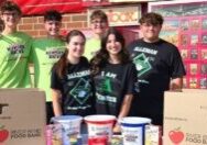 Alleman sophomores (front row, from left) Ava Sandoval-Murray and Autumn Atkinson display food donations collected during the 38th Annual Student Hunger Drive sponsored by the River Bend Food Bank of Davenport, Iowa. Back row, seniors Owen Cunningham, Tyler Wilden, Brennen Cunningham and Grant Masias. (Supplied photo)