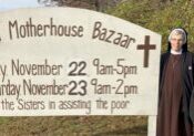 Sister Agnes Joseph Williams, O.S.F., major superior (left), and Sister Judith Ann Duvall, O.S.F. assistant major superior, stand beside the highway sign promoting their Annual Fall Bazaar Nov. 22-23. (The Catholic Post/Paul Thomas Moore)