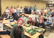 The students at St. Malachy Catholic School in Geneseo model hats knitted for them by their “lunch lady” Chelsie Pettie. Katrina Jensen/St. Malachy School

