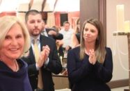 Jan Egbers, left, at the Central Catholic Highs School Saints Alive dinner auction on Oct. 24, where a $1M donation was announced from Egbers and Jim Bob Morris to expand the school’s counseling program. Egbers' nephew Chase Myers (center) and Chase's wife Katie lead the applause. (Provided photo/Rodger Singley)