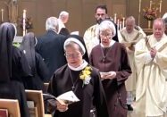 Sister Judith Ann Duvall, OSF, major superior to the Sisters of the Third Order of St. Francis, processes from the OSF motherhouse chapel at the conclusion of the Mass for her 60th anniversary jubilee celebration. Behind her is Sister Agnes Joseph, OSF, assistant major superior, and following to her right is Father Patrick Henehan, pastor of St. Jude Parish, Peoria, and diocesan vocation director of formation. To her left is Father Timothy Hepner, pastor of Immaculate Conception Parish, Monmouth. Photo: Mary Louise Moore 